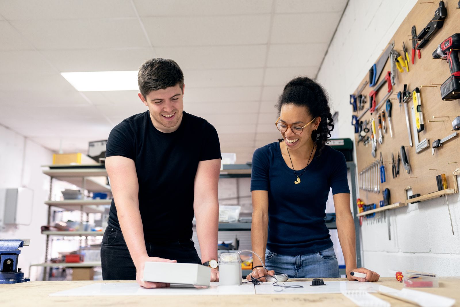 Two colleagues reviewing a component together in a workshop