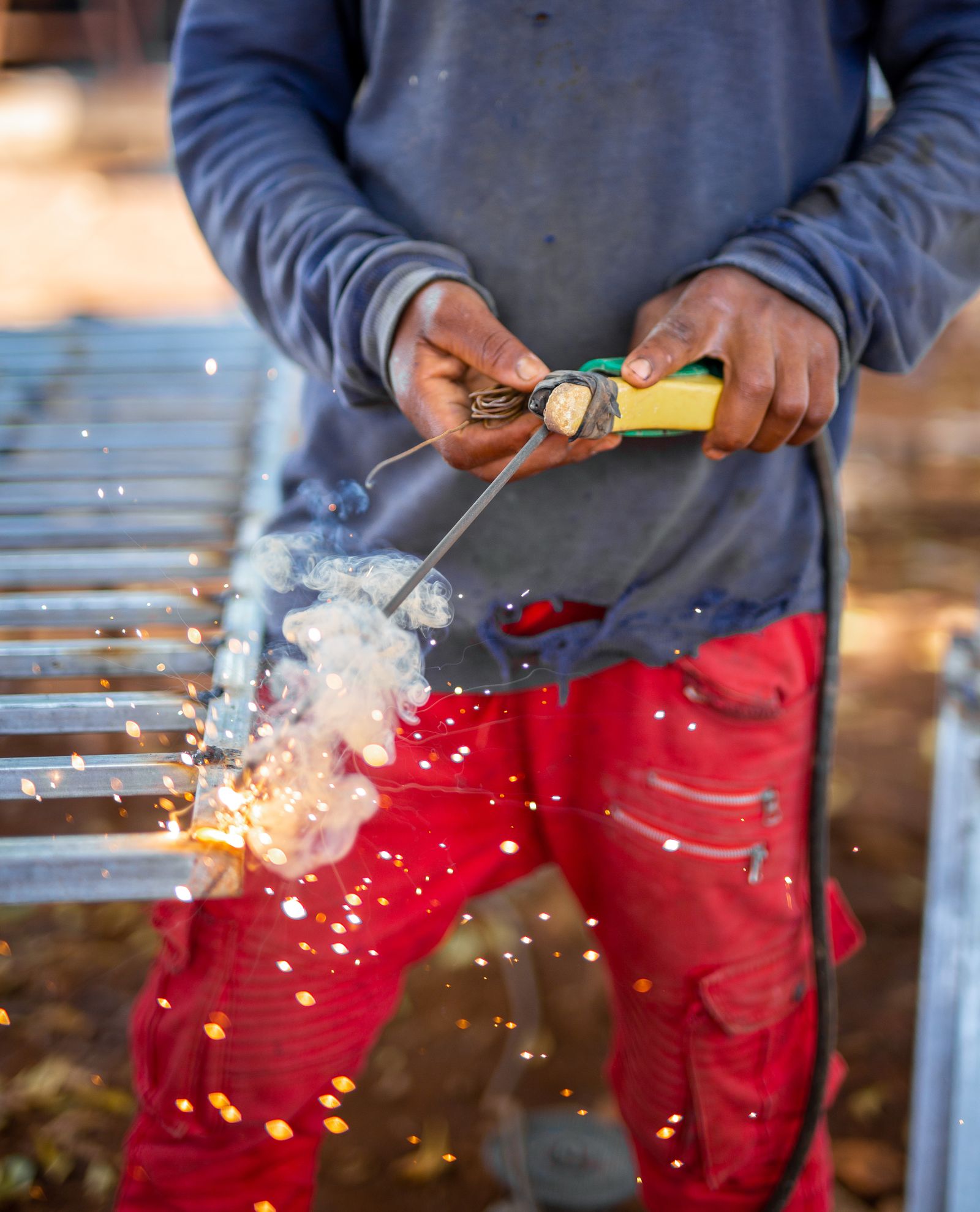 Close-up of a worker cutting steel with a shower of sparks